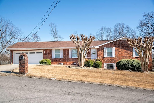 ranch-style house with driveway, brick siding, a shingled roof, an attached garage, and a front yard