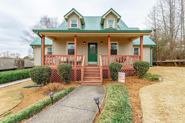 view of front facade featuring metal roof and a porch