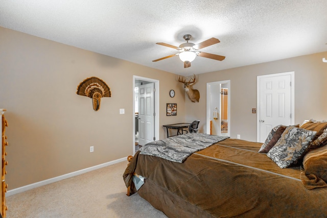 bedroom with a ceiling fan, baseboards, a textured ceiling, and light colored carpet