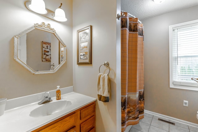 full bathroom featuring tile patterned flooring, plenty of natural light, vanity, and a textured ceiling