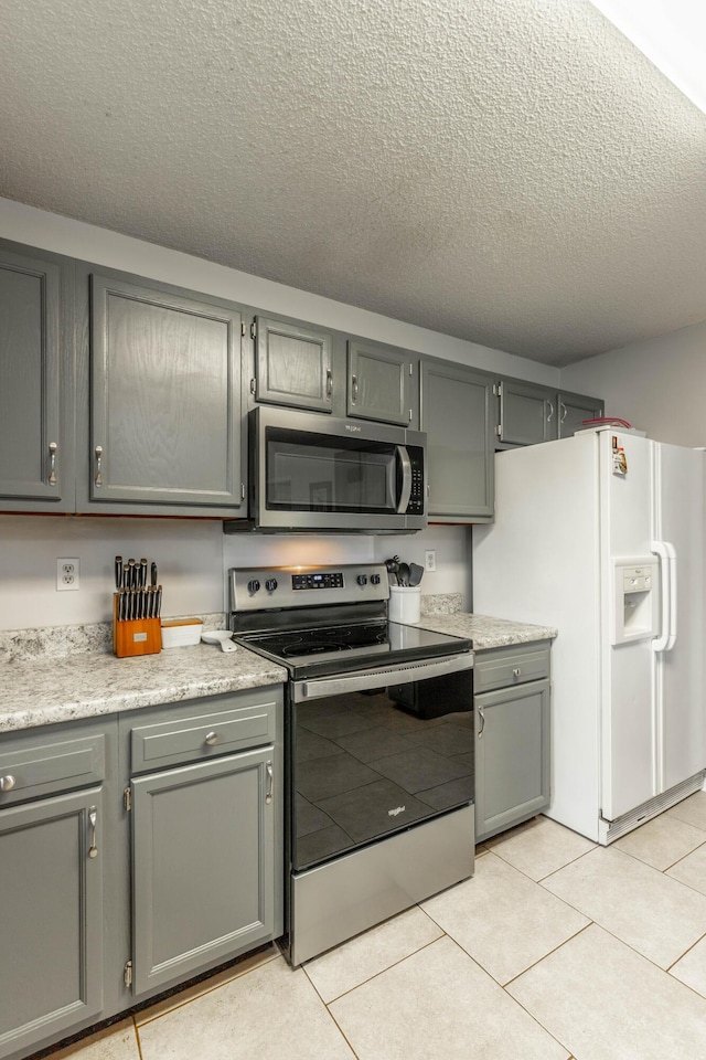 kitchen with light countertops, appliances with stainless steel finishes, and gray cabinets