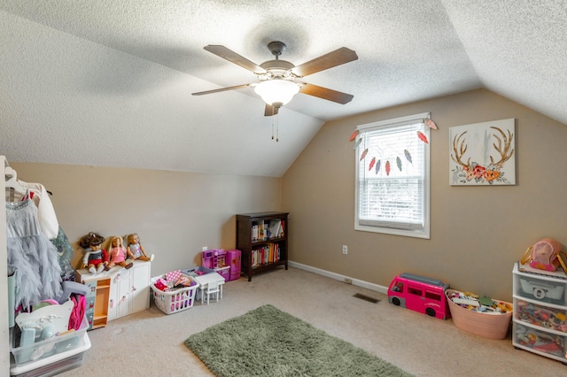 rec room featuring a textured ceiling, carpet floors, vaulted ceiling, and baseboards