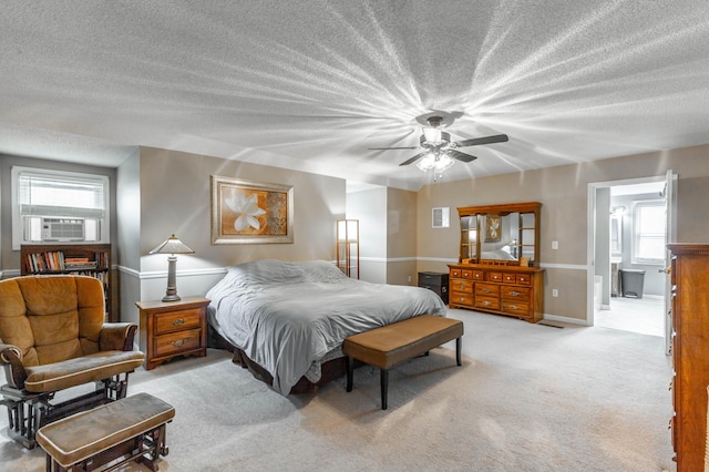 bedroom featuring ceiling fan, a textured ceiling, cooling unit, light carpet, and baseboards