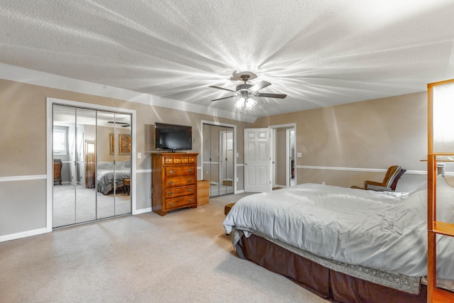 bedroom with baseboards, ceiling fan, a textured ceiling, carpet floors, and a closet