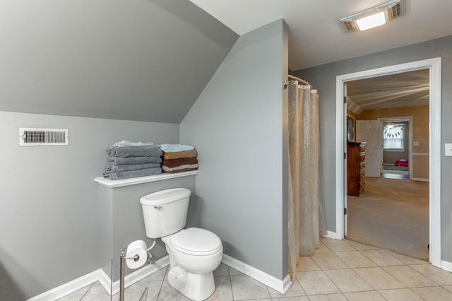 bathroom featuring toilet, baseboards, visible vents, and tile patterned floors