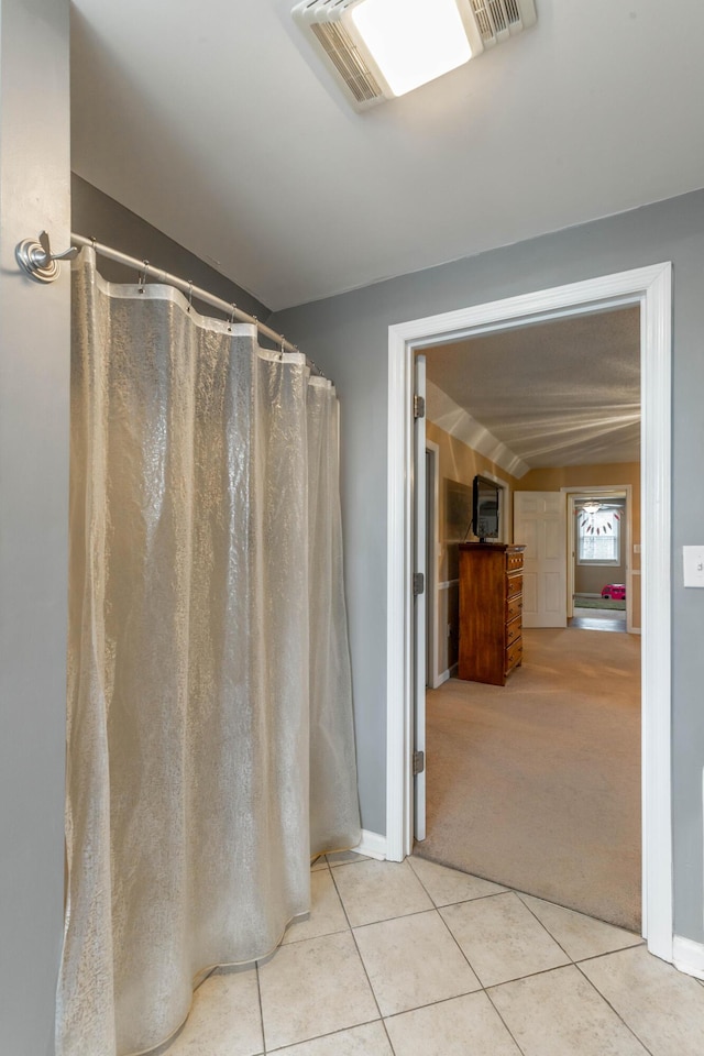 bathroom with baseboards, visible vents, and tile patterned floors