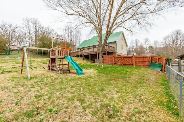 view of play area with a gate, a fenced backyard, and a yard