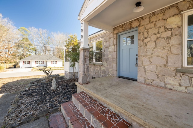 doorway to property featuring stone siding