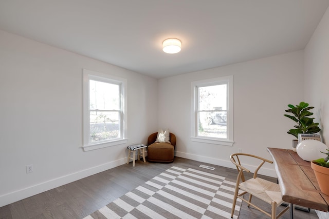 office space with plenty of natural light, light wood-style flooring, and baseboards