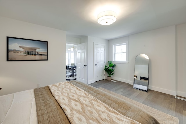 unfurnished bedroom with wood finished floors and baseboards