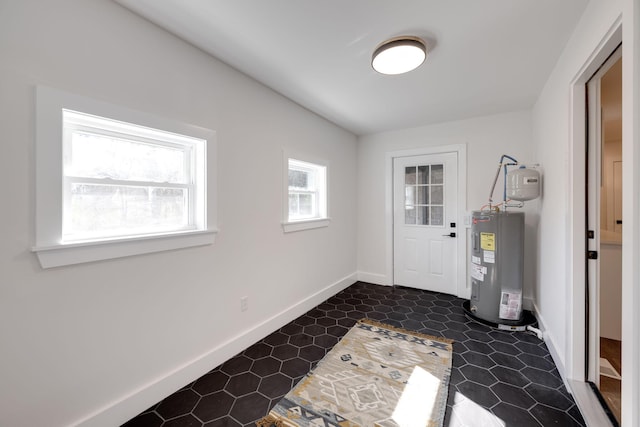 doorway with water heater and baseboards