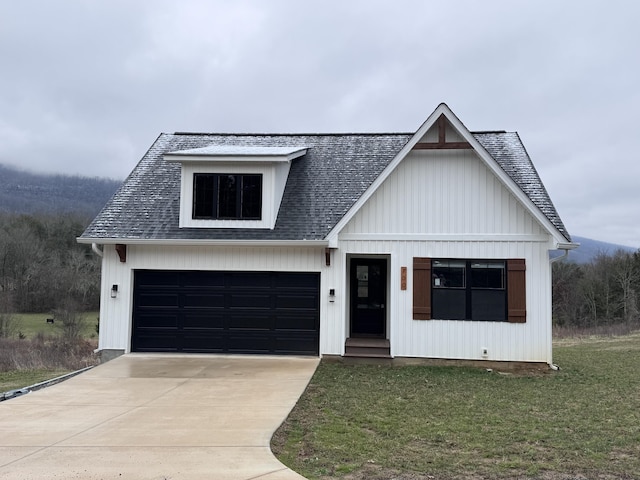 modern farmhouse featuring a front lawn, concrete driveway, and roof with shingles