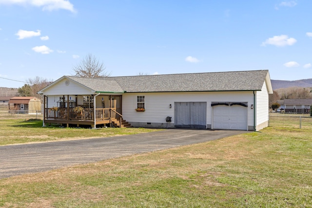 view of front of house with aphalt driveway, a garage, fence, crawl space, and a front yard