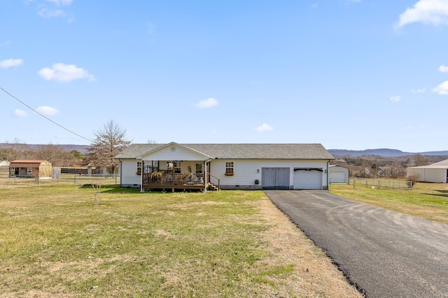 single story home featuring a garage, fence, crawl space, a wooden deck, and a front lawn