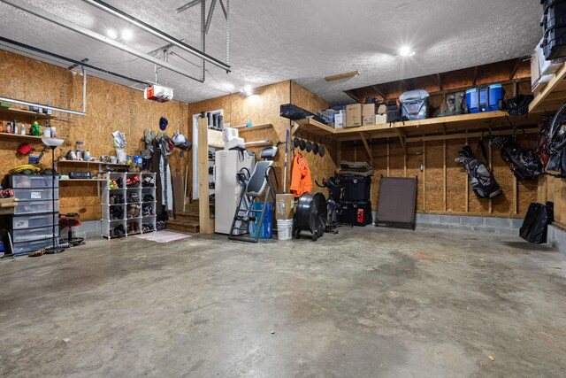 garage featuring a garage door opener and a workshop area