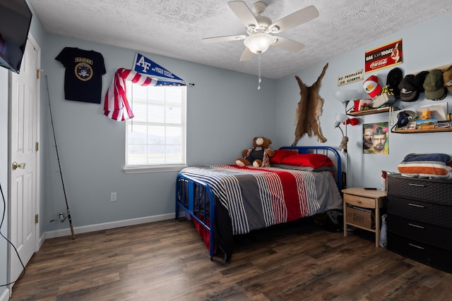 bedroom featuring a ceiling fan, a textured ceiling, baseboards, and wood finished floors