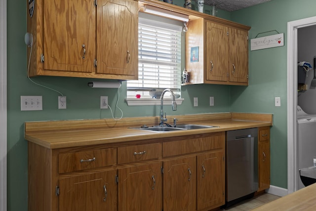 kitchen with a sink, brown cabinetry, light countertops, and dishwasher