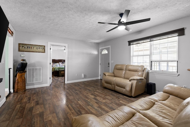 living room with visible vents, ceiling fan, a textured ceiling, wood finished floors, and baseboards