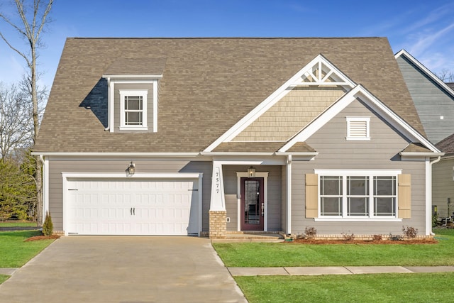 view of front of home with a front yard, roof with shingles, and driveway