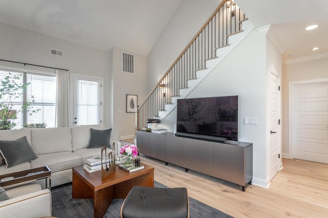 living area with light wood finished floors, stairs, visible vents, and recessed lighting