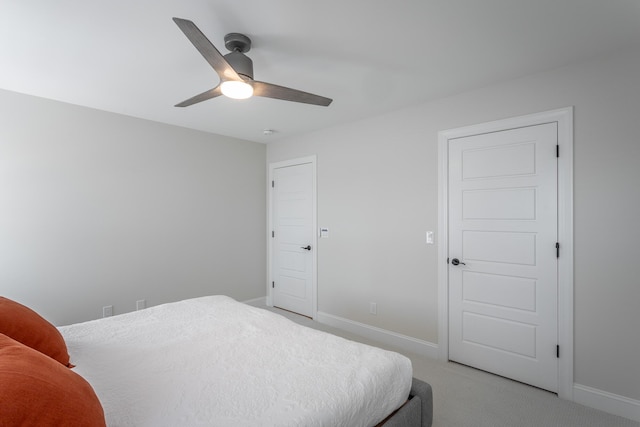 bedroom featuring light carpet, baseboards, and a ceiling fan