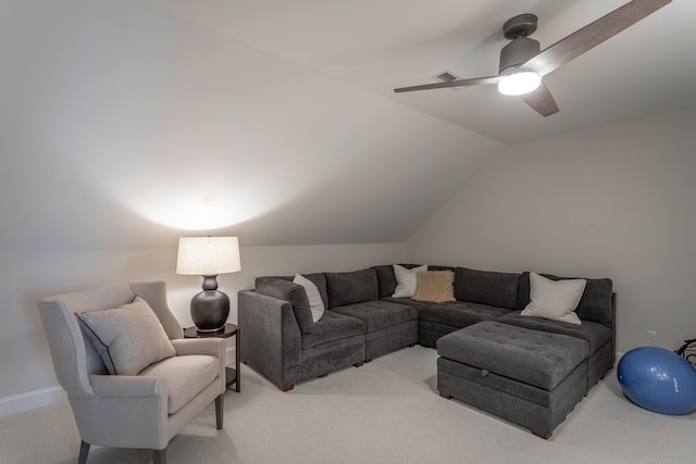 living room with lofted ceiling, ceiling fan, and light colored carpet