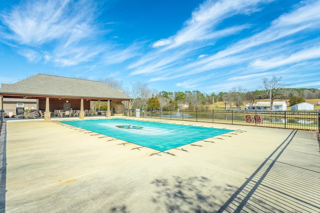 community pool featuring a patio and fence