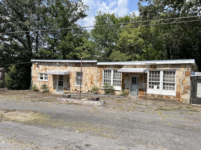 mid-century home with stone siding