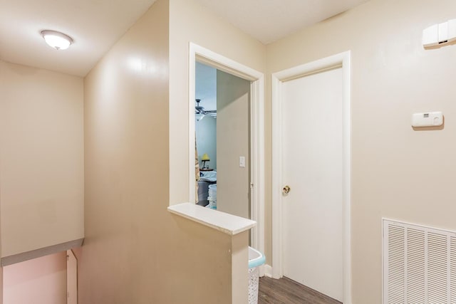 hallway featuring dark wood-style floors and visible vents