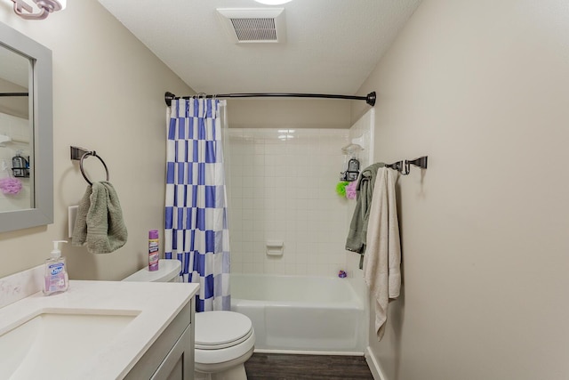 bathroom featuring shower / bath combo, visible vents, toilet, wood finished floors, and vanity