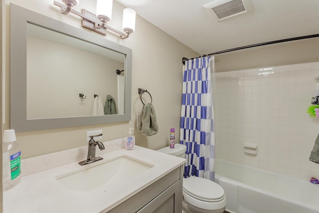 bathroom featuring shower / bath combination with curtain, visible vents, vanity, and toilet