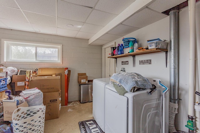 laundry area with washing machine and dryer, laundry area, and concrete block wall