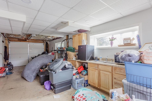 garage with freestanding refrigerator and a sink