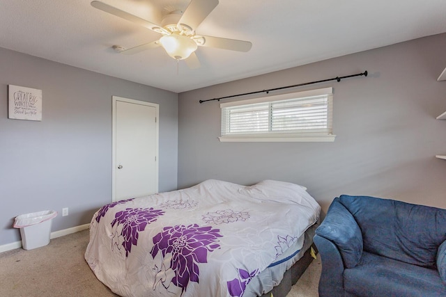 bedroom featuring a ceiling fan, light colored carpet, and baseboards