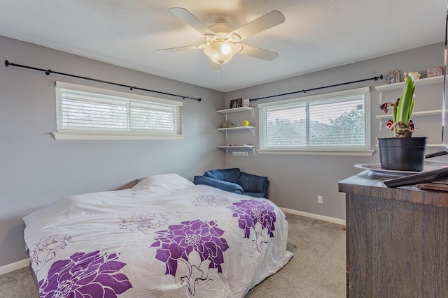 bedroom with light carpet, multiple windows, and baseboards