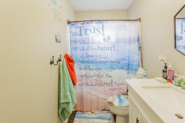 bathroom with toilet, curtained shower, and vanity