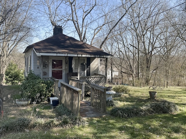 view of front of home featuring a front yard and a chimney