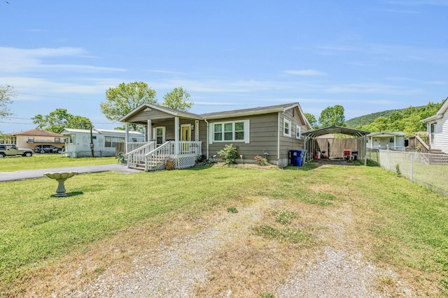 bungalow featuring a detached carport, driveway, a front lawn, and fence