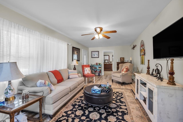 living area with light wood-style flooring and a ceiling fan