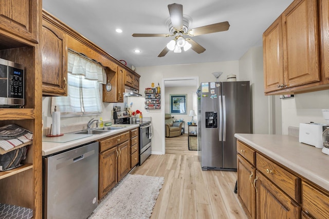 kitchen with stainless steel appliances, light countertops, and a sink