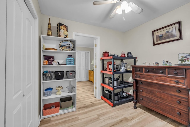 interior space with light wood finished floors and a ceiling fan