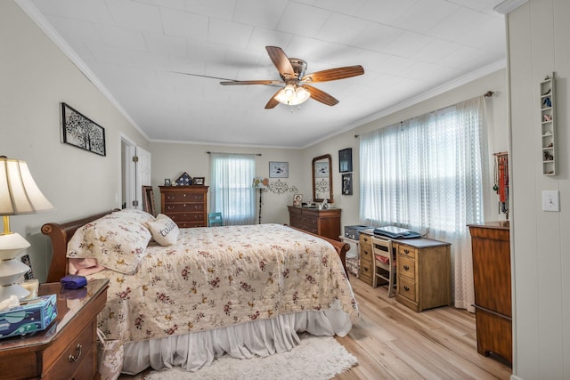 bedroom with ceiling fan, light wood finished floors, and crown molding