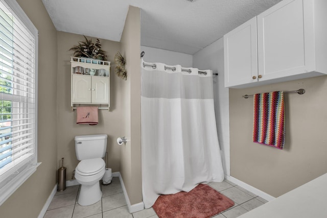 full bathroom with baseboards, toilet, and tile patterned floors