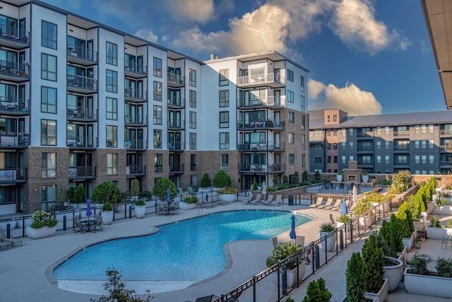 community pool with fence and a patio