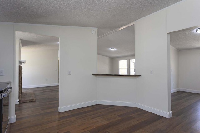 unfurnished room featuring a textured ceiling, dark wood-type flooring, and baseboards