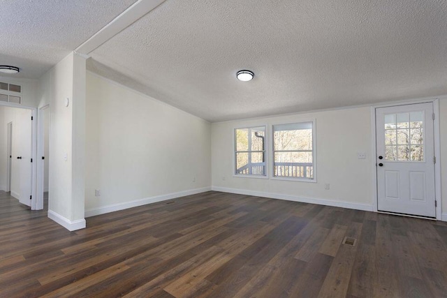 foyer featuring a healthy amount of sunlight, baseboards, and dark wood finished floors