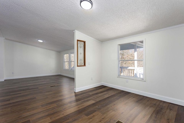 spare room with dark wood-style flooring, crown molding, a textured ceiling, and baseboards