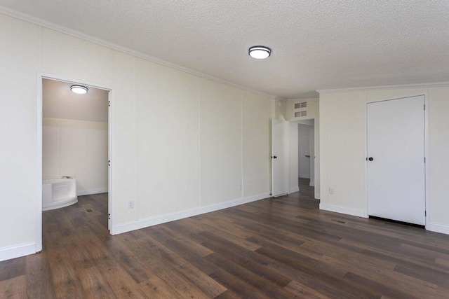 unfurnished bedroom with dark wood-type flooring, crown molding, and a textured ceiling