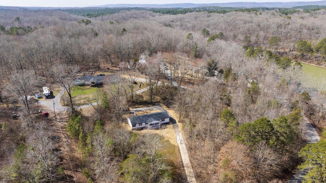 birds eye view of property featuring a wooded view