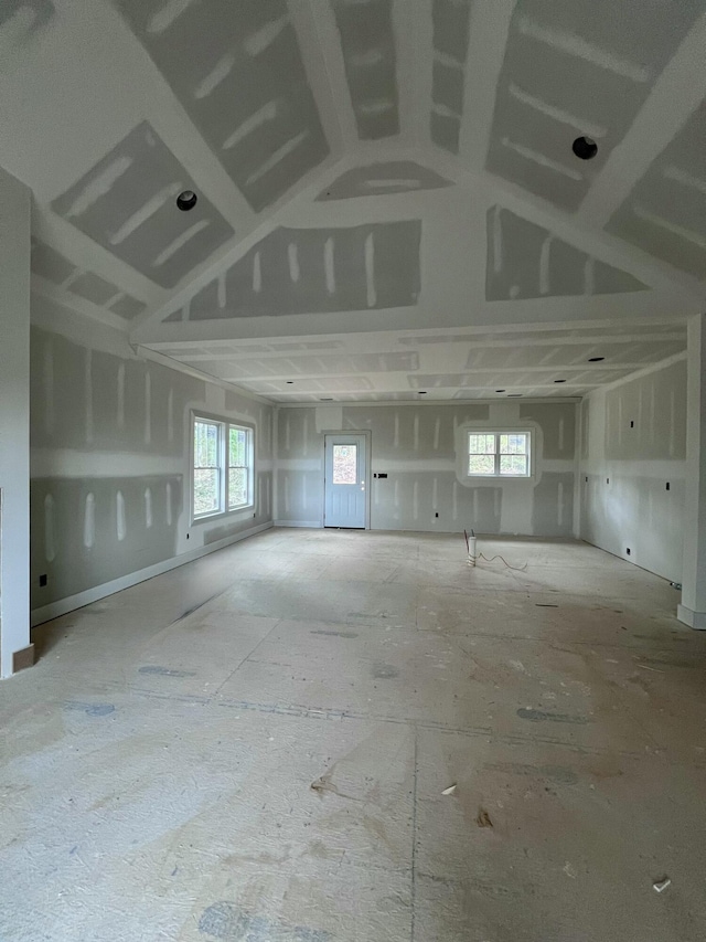 unfurnished room with lofted ceiling